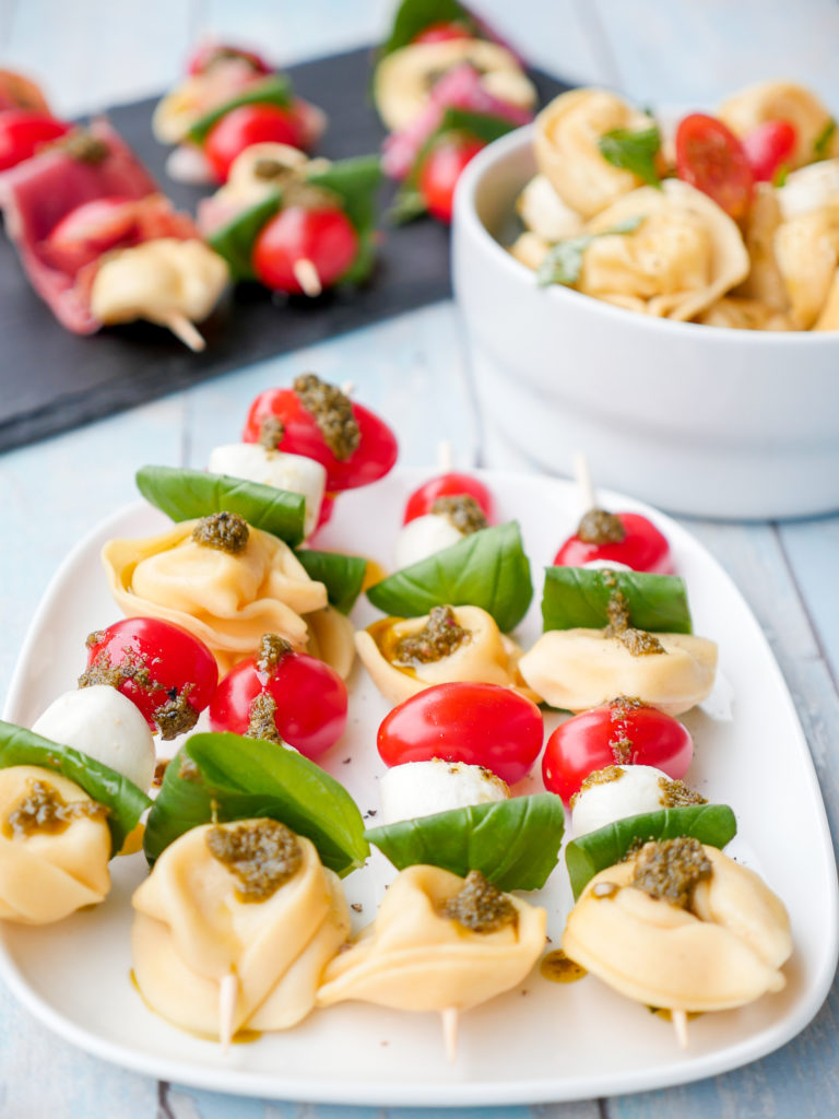 Schnelle Tortellinisalat-Spieße mit Tomaten, Mozzarella und grünem Pesto für das Grillen mit Kindern
