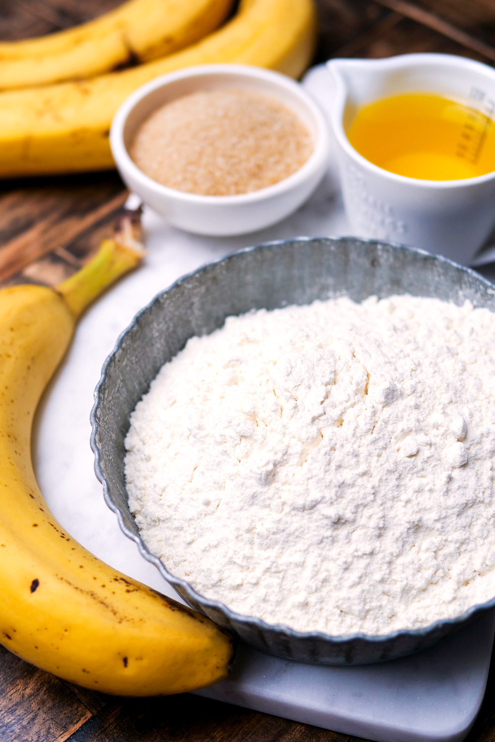Mehl, Zucker, Öl und Banane für Bananenbrot.